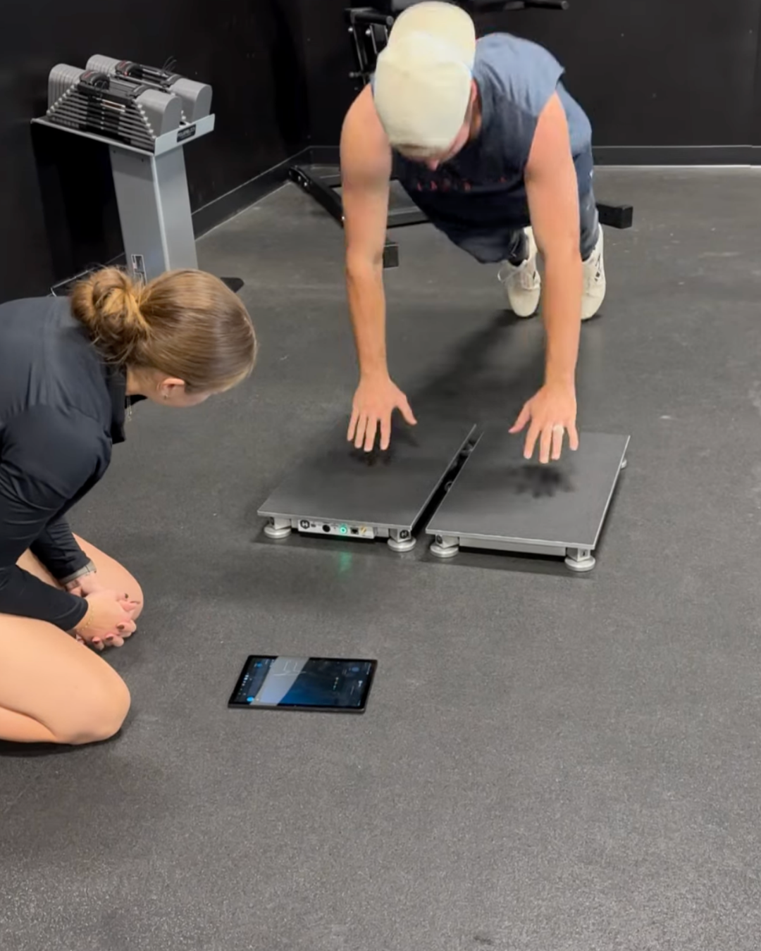 Athlete doing a pushup on a measuring scale.